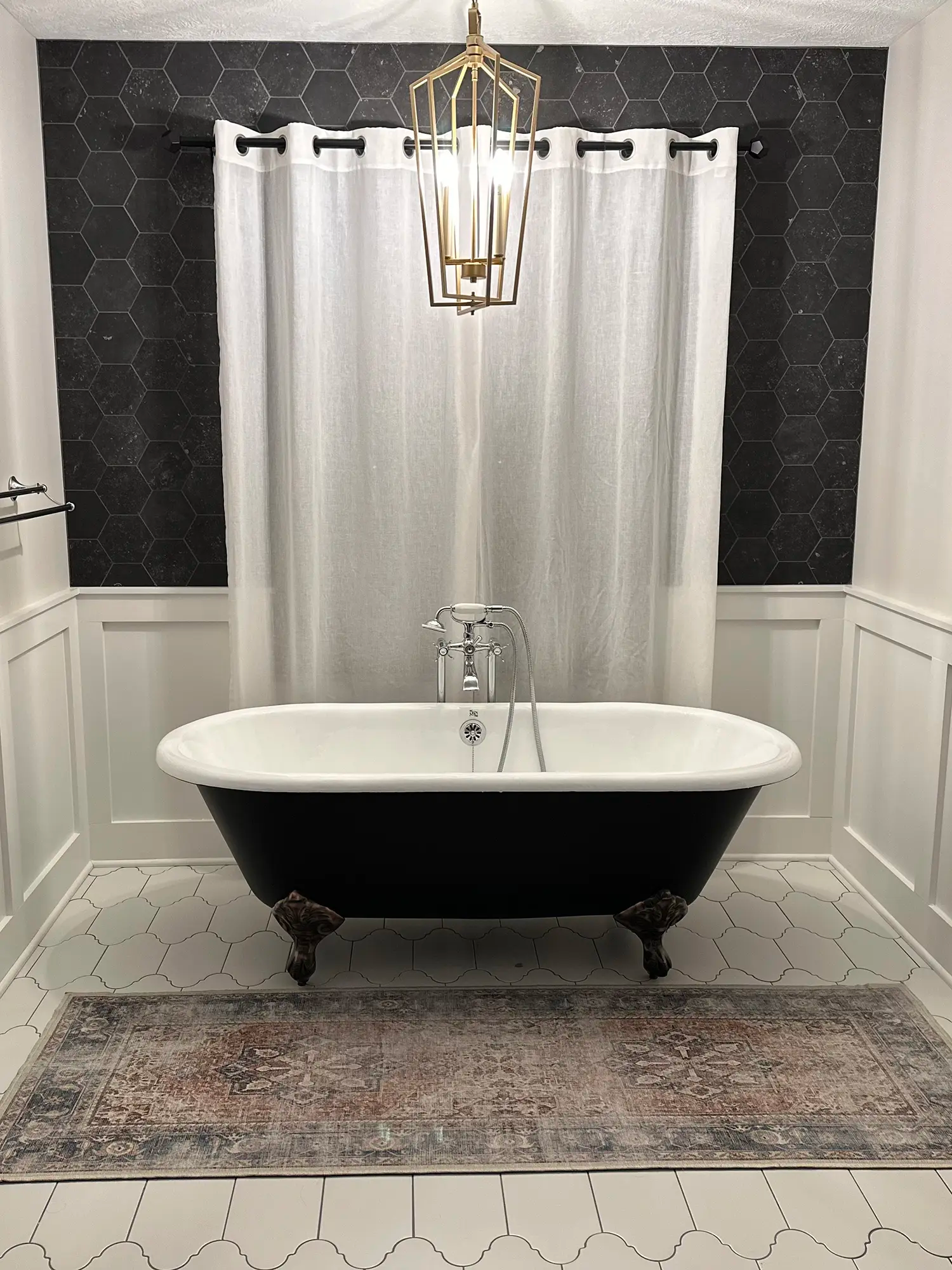 Bathroom tub with beautiful tile work and rug