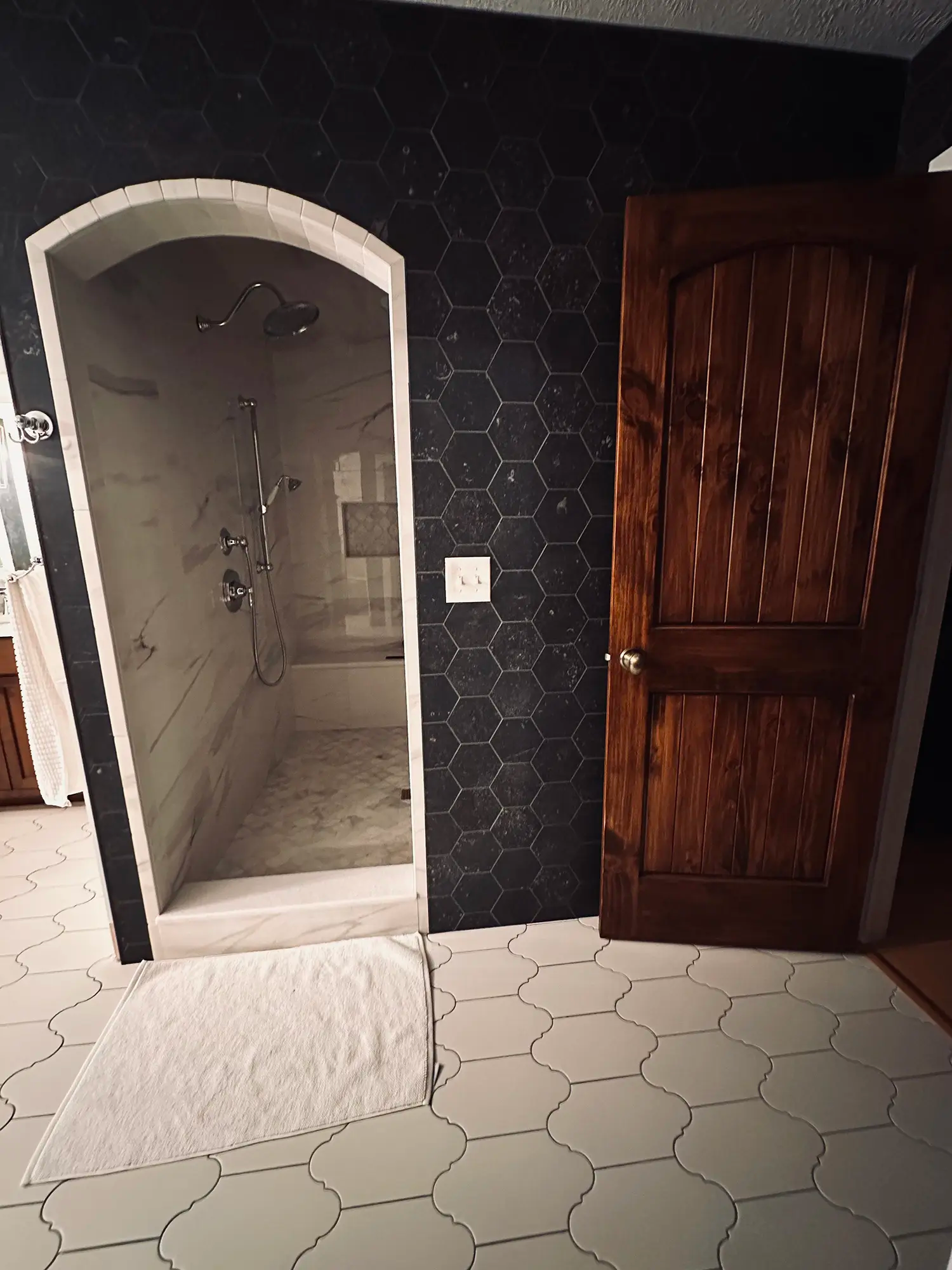 White marble walk in shower with beautiful tile work