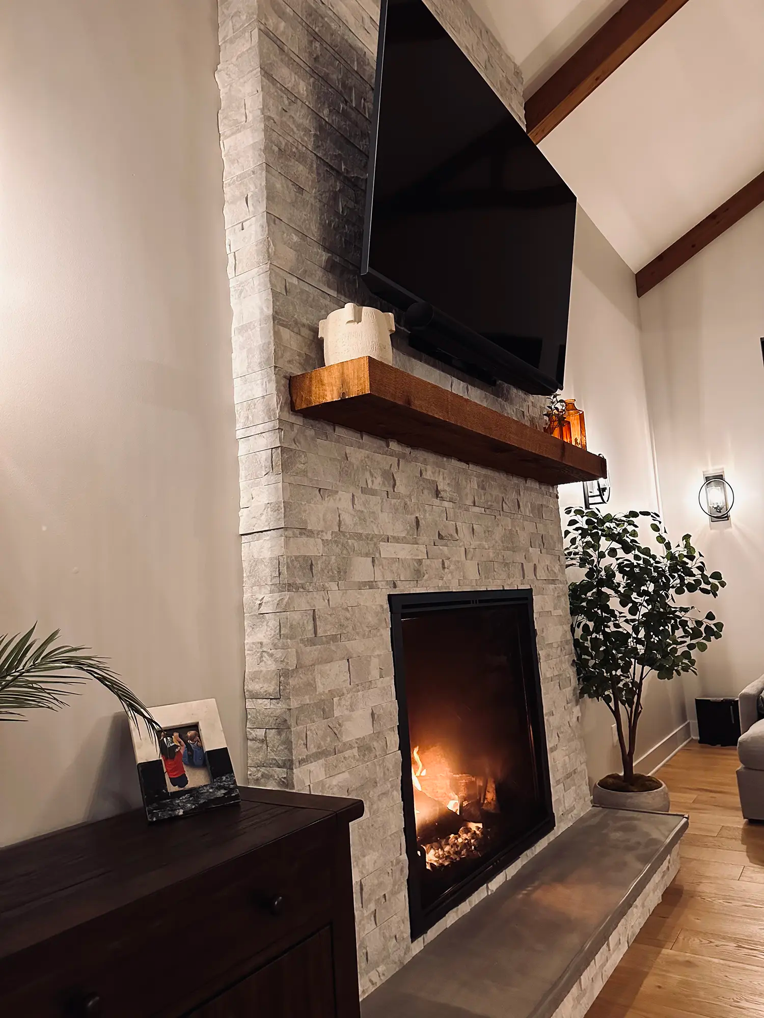 Stone mantel with fireplace and tv
